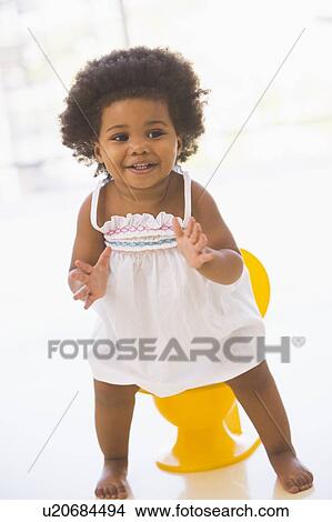 Baby indoors going on potty smiling View Large Photo Image Picture - Baby indoors going on potty smiling. Fotosearch