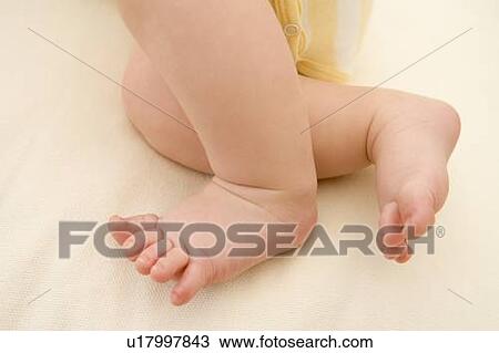 Stock Image - Baby lying indoors. Fotosearch