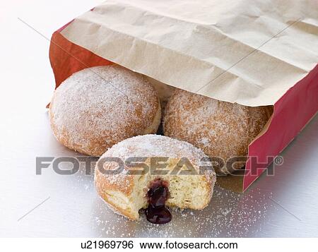 Stock Photograph - Bag Of Raspberry Jam Doughnuts With A Bite Taken. Fotosearch