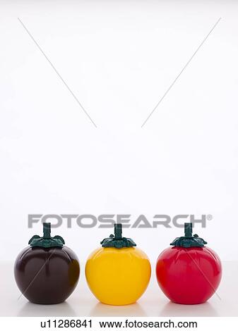 Stock Image - BBQ, Mustard And Ketchup Sauce Bottles, Three Tomato Shaped Sauce Bottles. Fotosearch