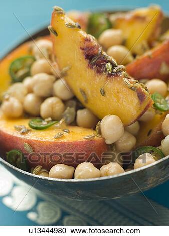 Stock Image - Bowl of Chick Pea and Peach Salad. Fotosearch