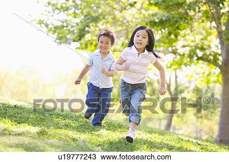 Brother and sister running outdoors smiling View Large Photo Image Stock Image - Brother and sister running outdoors smiling. Fotosearch