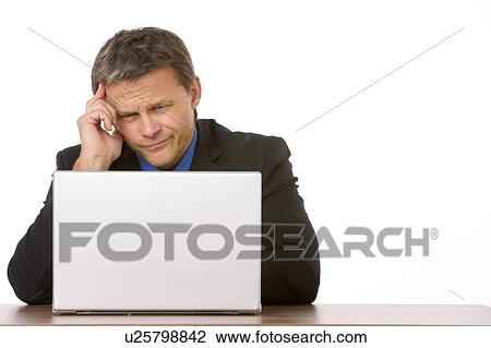 Businessman Frowning While Looking At Laptop View Large Photo Image Stock Image - Businessman Frowning While Looking At Laptop . Fotosearch