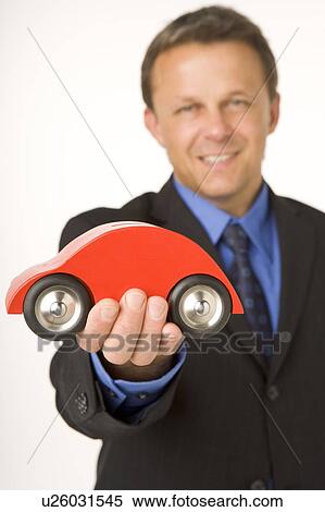 Businessman Holding A Toy Car View Large Photo Image Stock Photography - Businessman Holding A Toy Car . Fotosearch