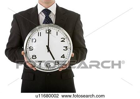 Stock Image - Businessman Holding Clock. Fotosearch