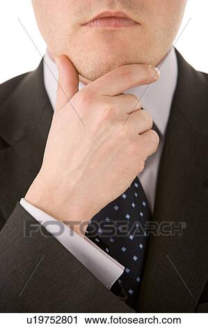 Stock Image - Businessman Holding His Chin . Fotosearch
