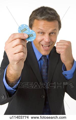 Picture - Businessman Holding Poker Chips To The Value Of $2000. Fotosearch