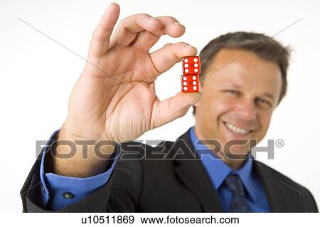 Stock Photo - Businessman Holding Two Red Dice . Fotosearch