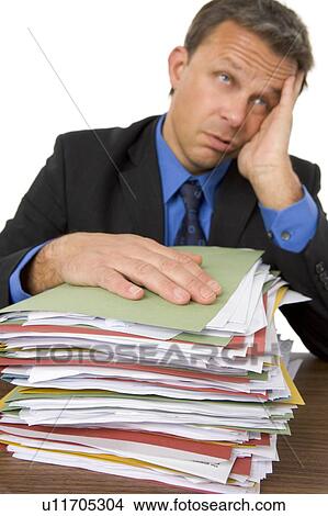 Businessman Overwhelmed By Paperwork View Large Photo Image Picture - Businessman Overwhelmed By Paperwork. Fotosearch