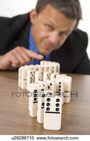 Businessman Playing With Dominos View Large Photo Image Stock Image - Businessman Playing With Dominos. Fotosearch