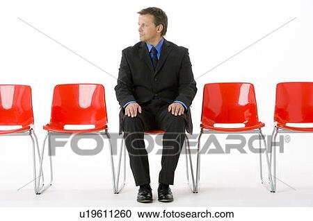 Businessman Sitting In Row Of Empty Chairs View Large Photo Image Stock Image - Businessman Sitting In Row Of Empty Chairs . Fotosearch