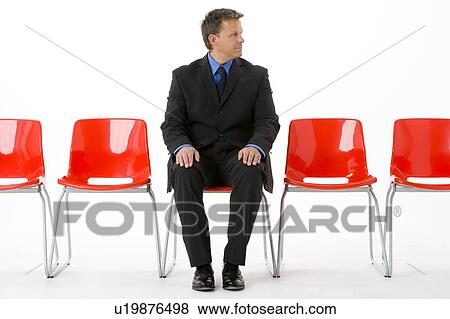 Businessman Sitting In Row Of Empty Chairs View Large Photo Image Stock Photo - Businessman Sitting In Row Of Empty Chairs . Fotosearch