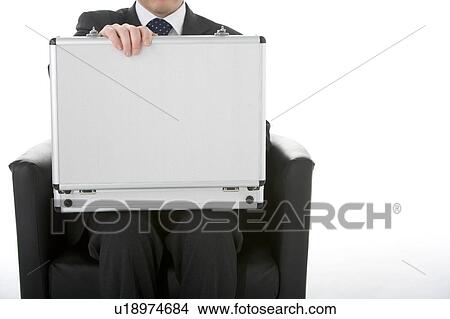 Picture - Businessman Sitting Opening Brief Case . Fotosearch