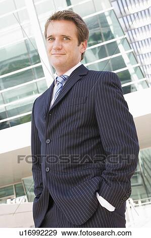 Businessman standing outdoors View Large Photo Image Stock Photo - Businessman standing outdoors. Fotosearch