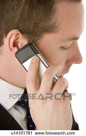 Stock Image - Businessman Talking On Mobile Phone . Fotosearch