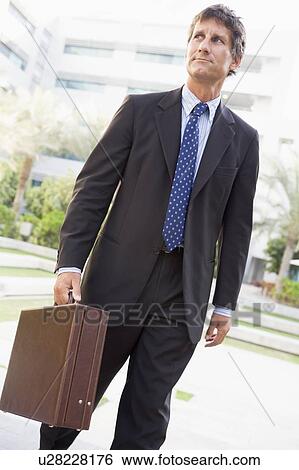 Businessman walking outdoors View Large Photo Image Stock Photograph - Businessman walking outdoors. Fotosearch