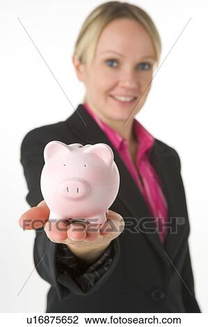 Stock Image - Businesswoman Holding Piggy Bank . Fotosearch