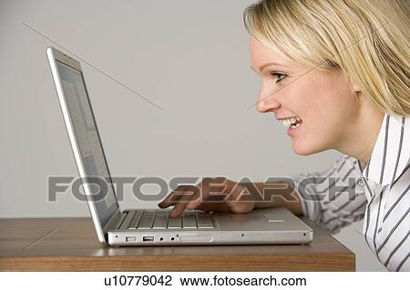 Stock Image - Businesswoman Looking At Laptop . Fotosearch