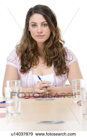 Stock Photo - Businesswoman sitting in boardroom. Fotosearch