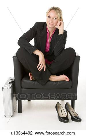 Businesswoman Sitting In Leather Chair With Her Shoes Off View Large Photo Image Stock Image - Businesswoman Sitting In Leather Chair With Her Shoes Off. Fotosearch