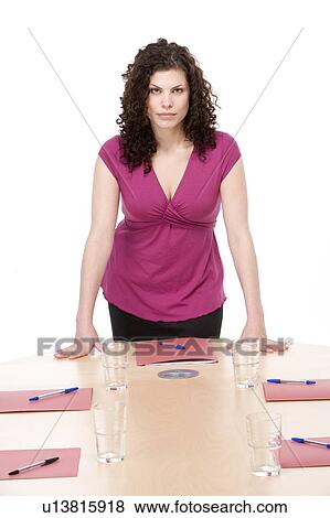 Stock Photo - Businesswoman standing in boardroom. Fotosearch