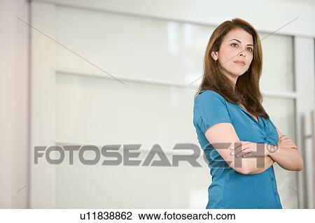 Businesswoman standing indoors View Large Photo Image Stock Image - Businesswoman standing indoors. Fotosearch
