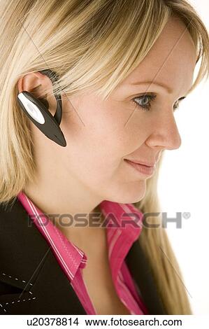 Picture - Businesswoman Talking On Hands Free Phone . Fotosearch