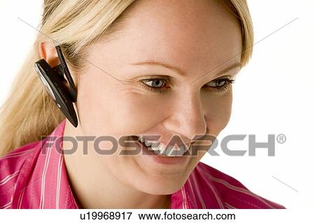 Stock Photo - Businesswoman Talking On Hands Free Phone . Fotosearch