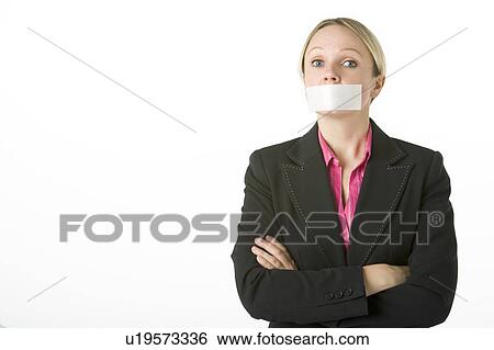 Stock Photograph - Businesswoman With Her Arms Folded And Mouth Taped Shut. Fotosearch