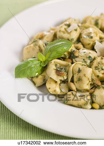 Chicken and Mushroom Tortelinni with Pesto and Pine Nuts View Large Photo Image Stock Image - Chicken and Mushroom Tortelinni with Pesto and Pine Nuts. Fotosearch