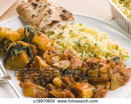 Picture - Chicken Bhoona, Sag Aloo, Pilau Rice And Naan Bread. Fotosearch