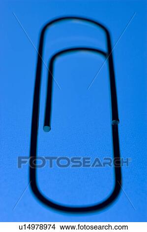 Close Up Of A Blue Paperclip, Against A Blue Background View Large Photo Image Picture - Close Up Of A Blue Paperclip, Against A Blue Background. Fotosearch