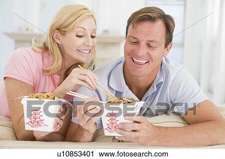 Stock Image - Couple Eating Takeaway meal, mealtime Together. Fotosearch