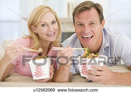 Stock Photo - Couple Eating Takeaway meal, mealtime Together. Fotosearch