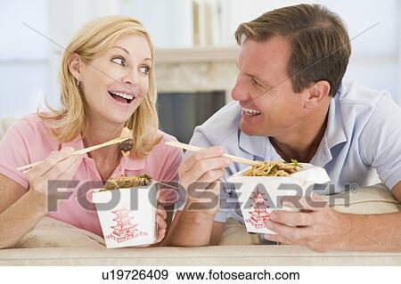 Stock Photo - Couple Eating Takeaway meal, mealtime Together. Fotosearch