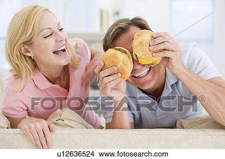 Couple Enjoying Burgers Together View Large Photo Image Picture - Couple Enjoying Burgers Together. Fotosearch