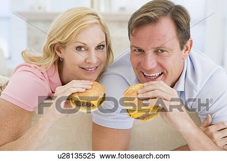 Couple Enjoying Burgers Together View Large Photo Image Stock Photography - Couple Enjoying Burgers Together. Fotosearch