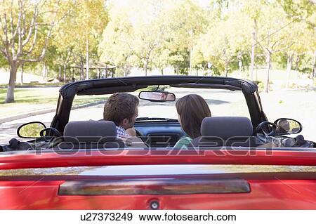 Stock Photo - Couple in convertible car. Fotosearch