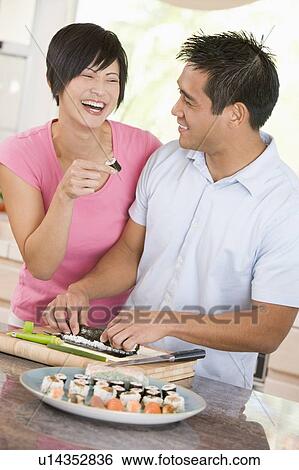 Stock Photograph - Couple Preparing Sushi Together . Fotosearch