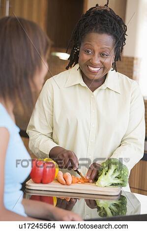Picture - Couple With Daughter Preparing meal, mealtime. Fotosearch