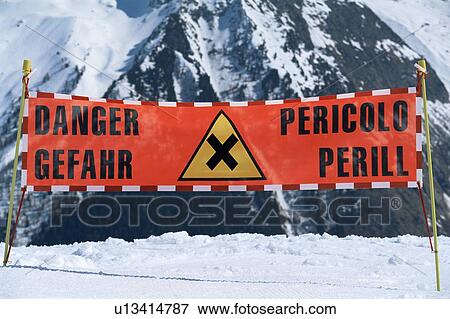 Stock Photo - Danger sign on snowy mountain (selective focus). Fotosearch
