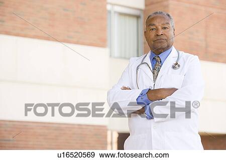 Stock Photo - Doctor Standing Outside A Hospital. Fotosearch