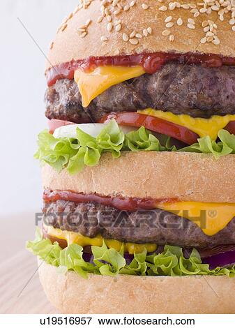 Double Cheese Burger In A Sesame Seed Bun View Large Photo Image Stock Photo - Double Cheese Burger In A Sesame Seed Bun. Fotosearch