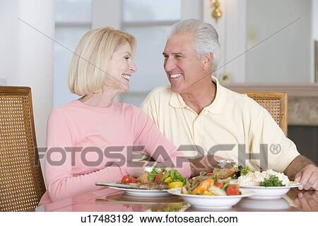 Stock Image - Elderly Couple Enjoying Healthy meal, mealtime Together. Fotosearch