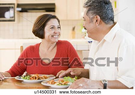 Stock Image - Elderly Couple Enjoying meal, mealtime Together. Fotosearch