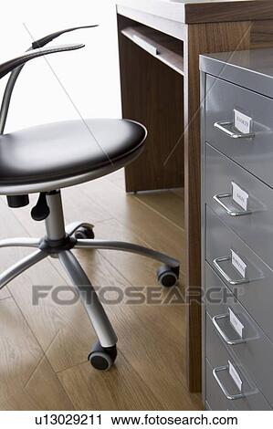 Empty Chair And Desk With Filing Cabinet View Large Photo Image Stock Image - Empty Chair And Desk With Filing Cabinet. Fotosearch