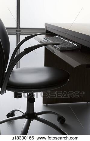 Empty Office Chair And Desk With Computer Keyboard View Large Photo Image Stock Photograph - Empty Office Chair And Desk With Computer Keyboard. Fotosearch