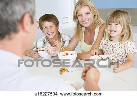Family Eating A meal, mealtime Together View Large Photo Image Picture - Family Eating A meal, mealtime Together . Fotosearch