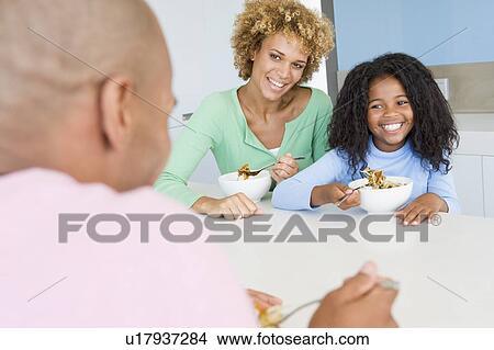 Picture - Family Eating A meal, mealtime Together . Fotosearch