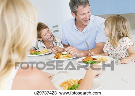 Family Eating A meal, mealtime Together View Large Photo Image Stock Image - Family Eating A meal, mealtime Together . Fotosearch